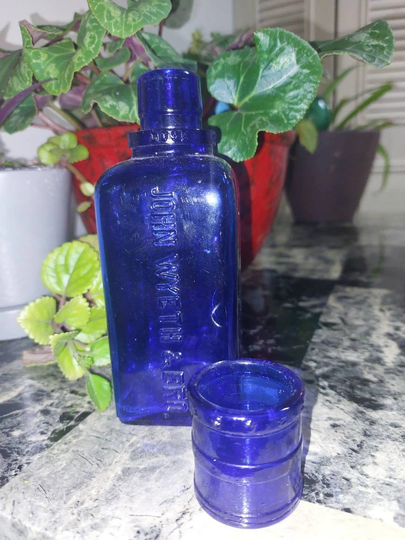 Blue Cobalt Glass With Top Used As A Measuring Device For This Medicine Bottle